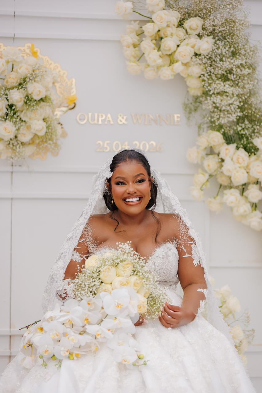 Close portrait of a smiling bride with white florals and orchids